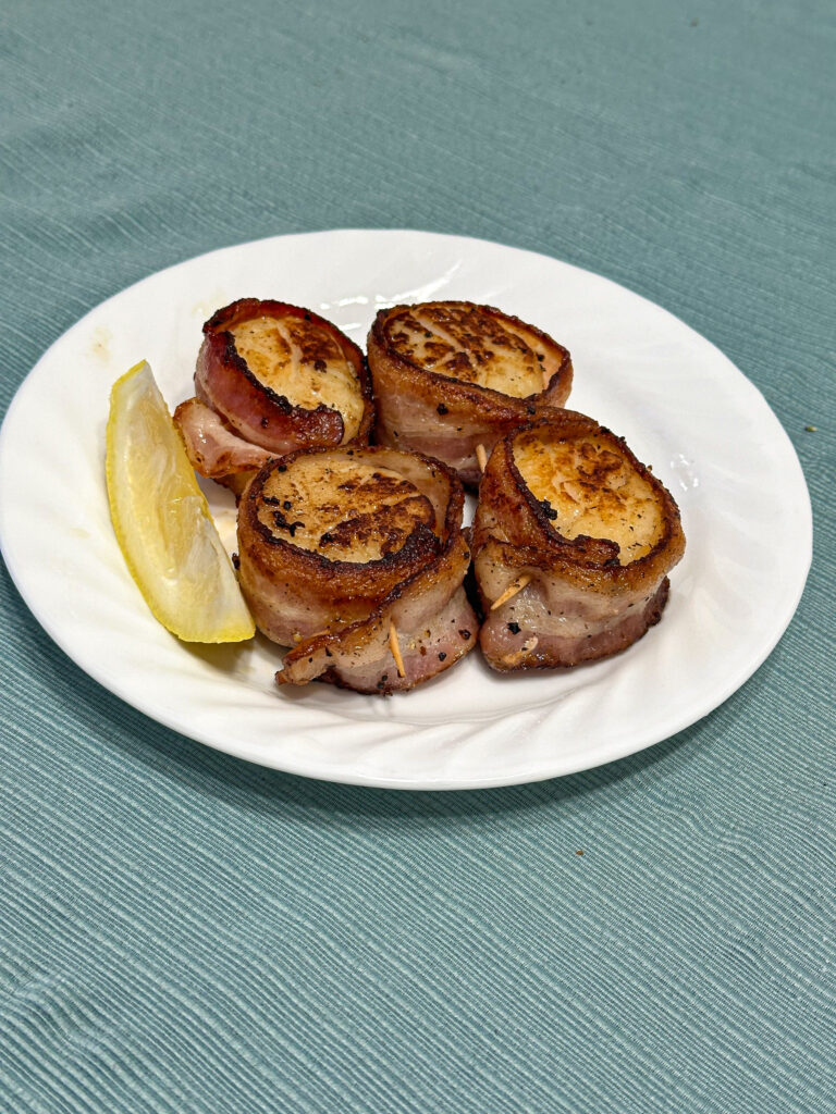 Plated bacon wrapped scallops