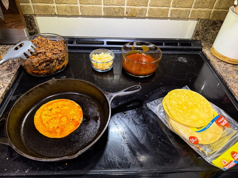 Preparing birria tacos